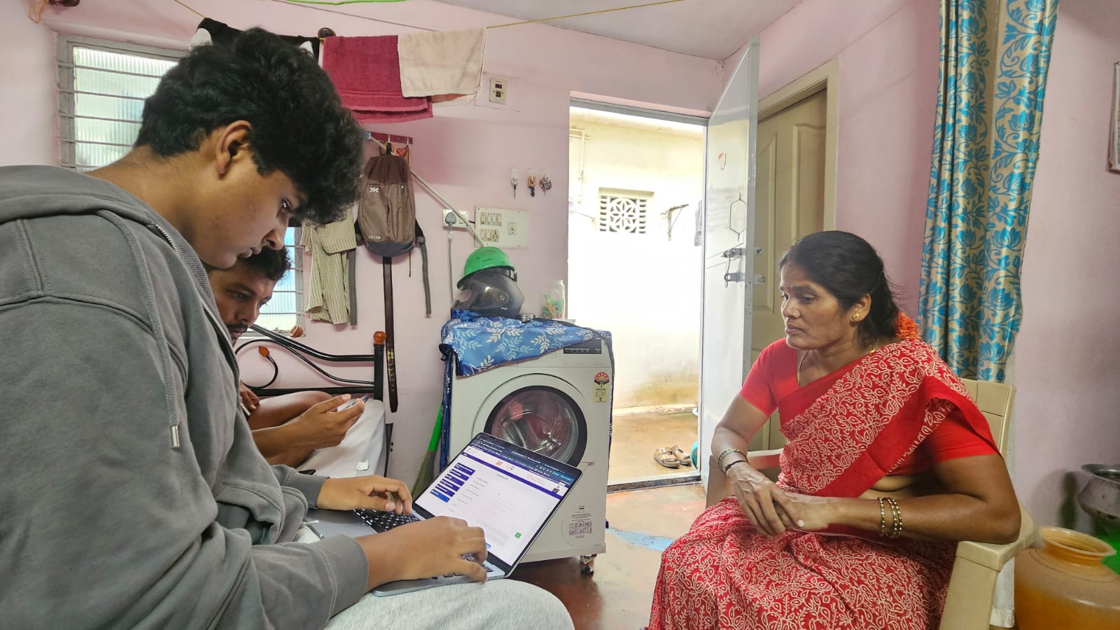Government scheme enrollment — home visit with a participant